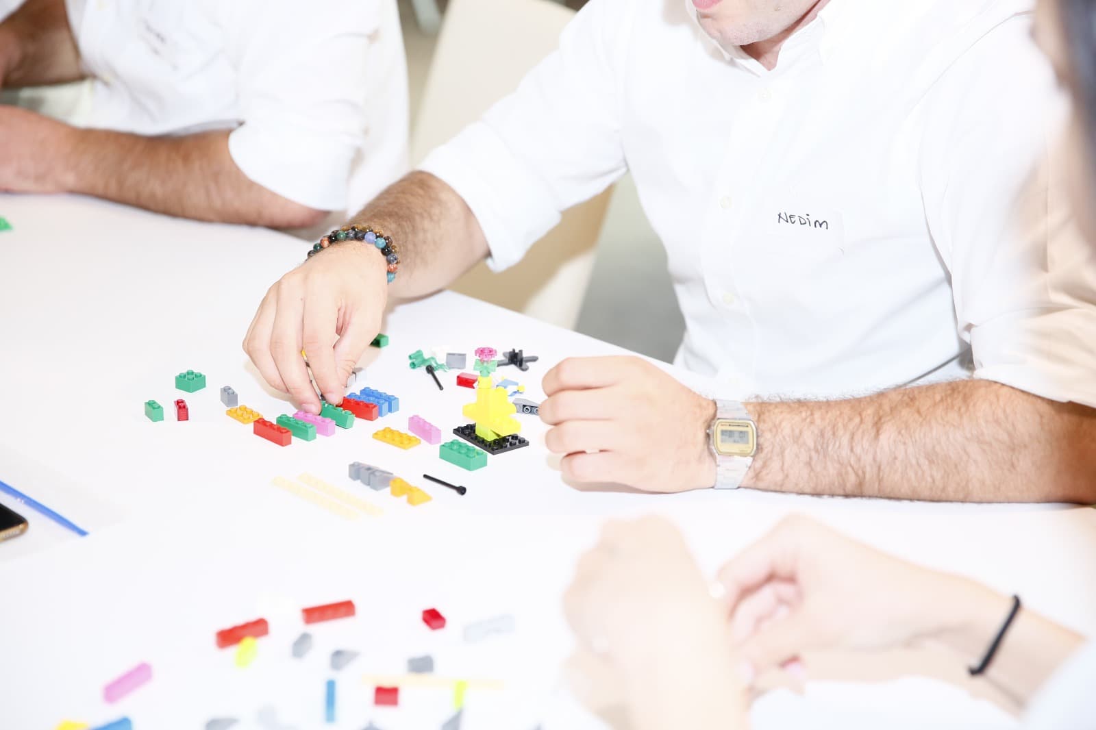 A participant placing a brick while building his model