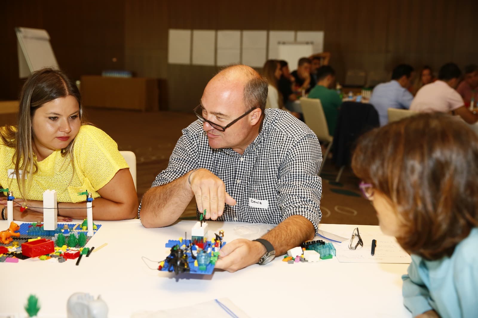 A participant explaining the story behind his model to his colleagues