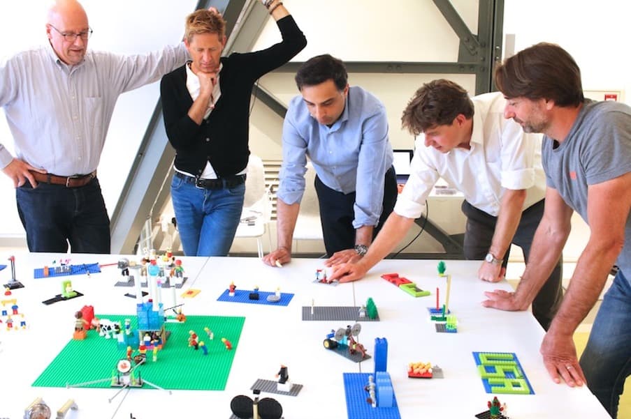 A team standing around the shared landscape they built together