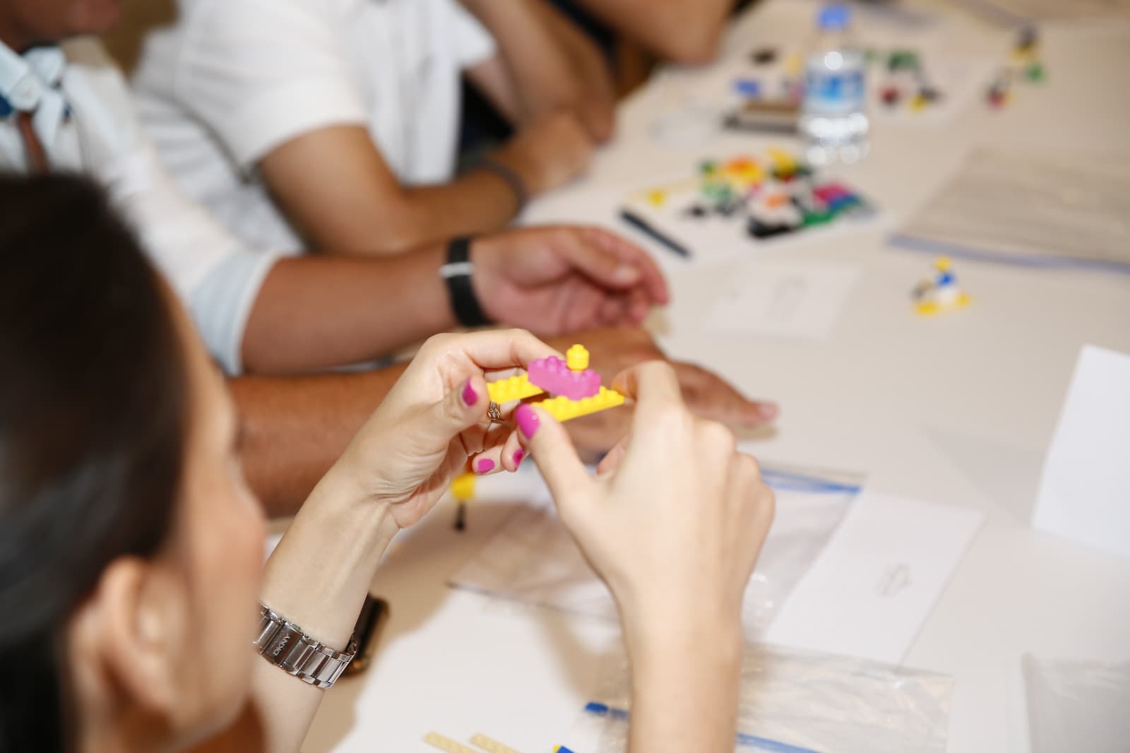 Close-up of a participant assembling two bricks